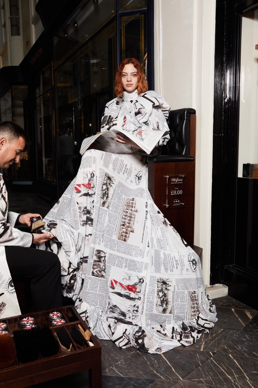 Loose auburn waves in a newsprint-print couture look.