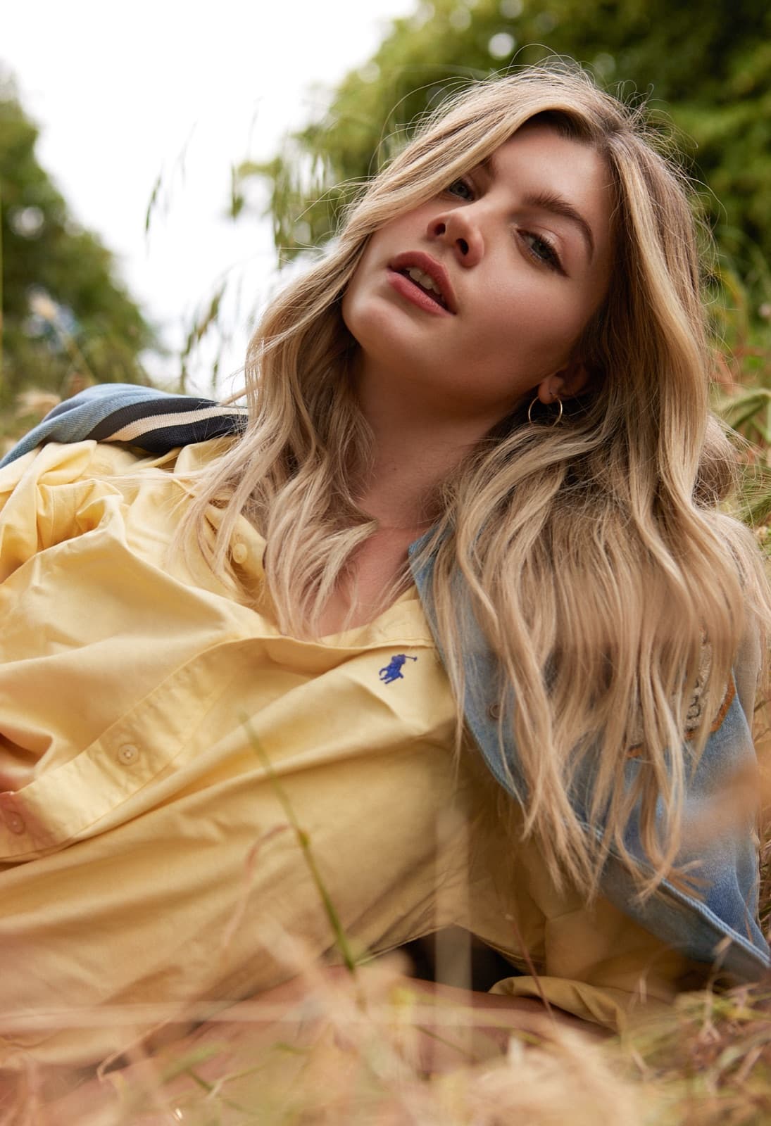 Tousled blonde caught in golden field light.